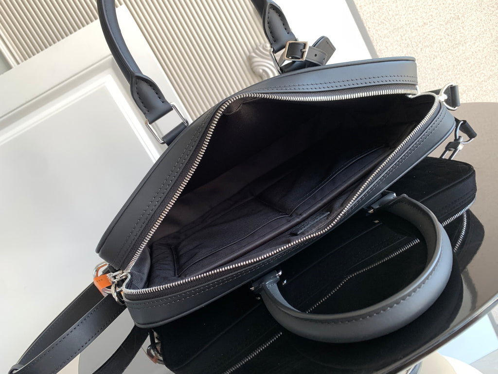 Dark handbag interior view with zip top and side pocket, shown open