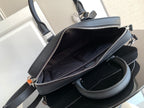 Dark handbag interior view with zip top and side pocket, shown open