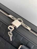 Dark woven handbag with silver zipper pulls and key ring clip
