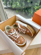 Louis Vuitton unisex sneakers in a box, brown uppers with white laces and motif print.