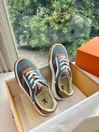 Louis Vuitton blue plaid low-top sneakers with white laces and beige gum sole, side view.