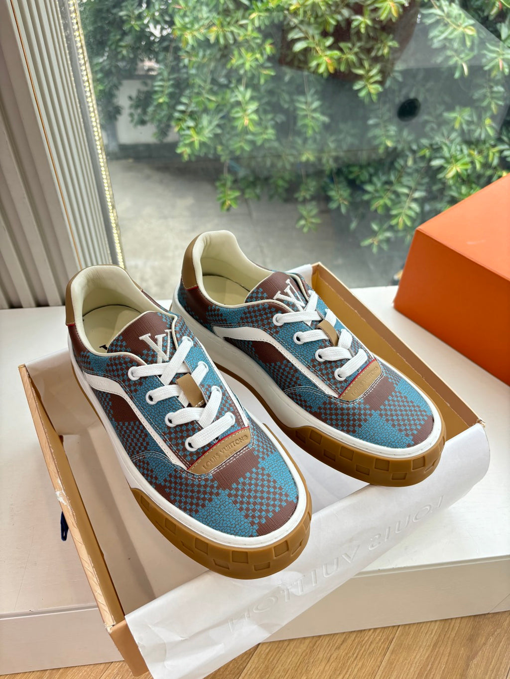 Louis Vuitton plaid low-top sneakers with white laces and gum rubber sole, blue and brown.