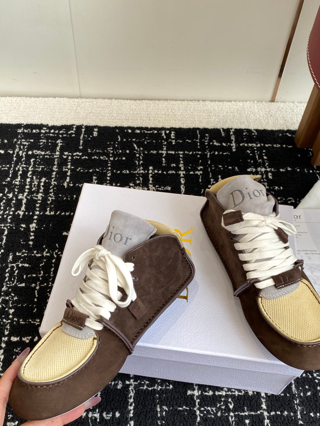 Dior unisex high-top sneakers on box, brown suede pair with white laces and tan mesh