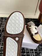 Dior unisex high-top sneakers outsole view with textured rubber tread and brown upper