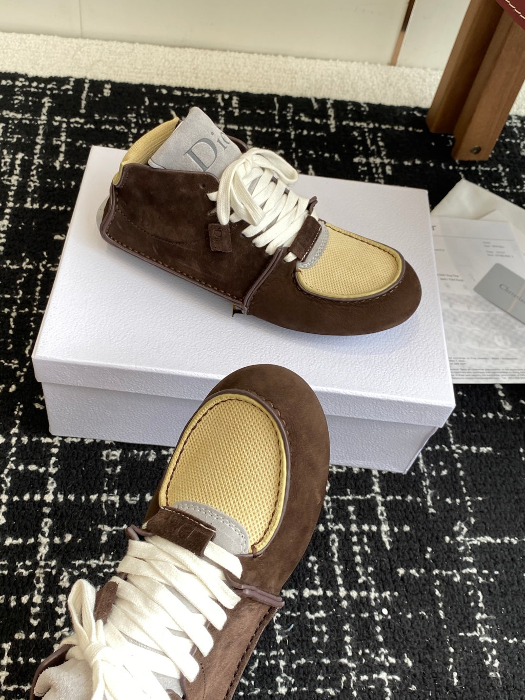 Dior unisex high-top sneakers, close-up angle, brown suede with white laces and tan mesh