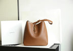 YSL bucket bag in brown leather with gold YSL charm and top handle straps