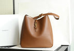 YSL bucket bag in brown leather with gold-tone charm at center and handle strap