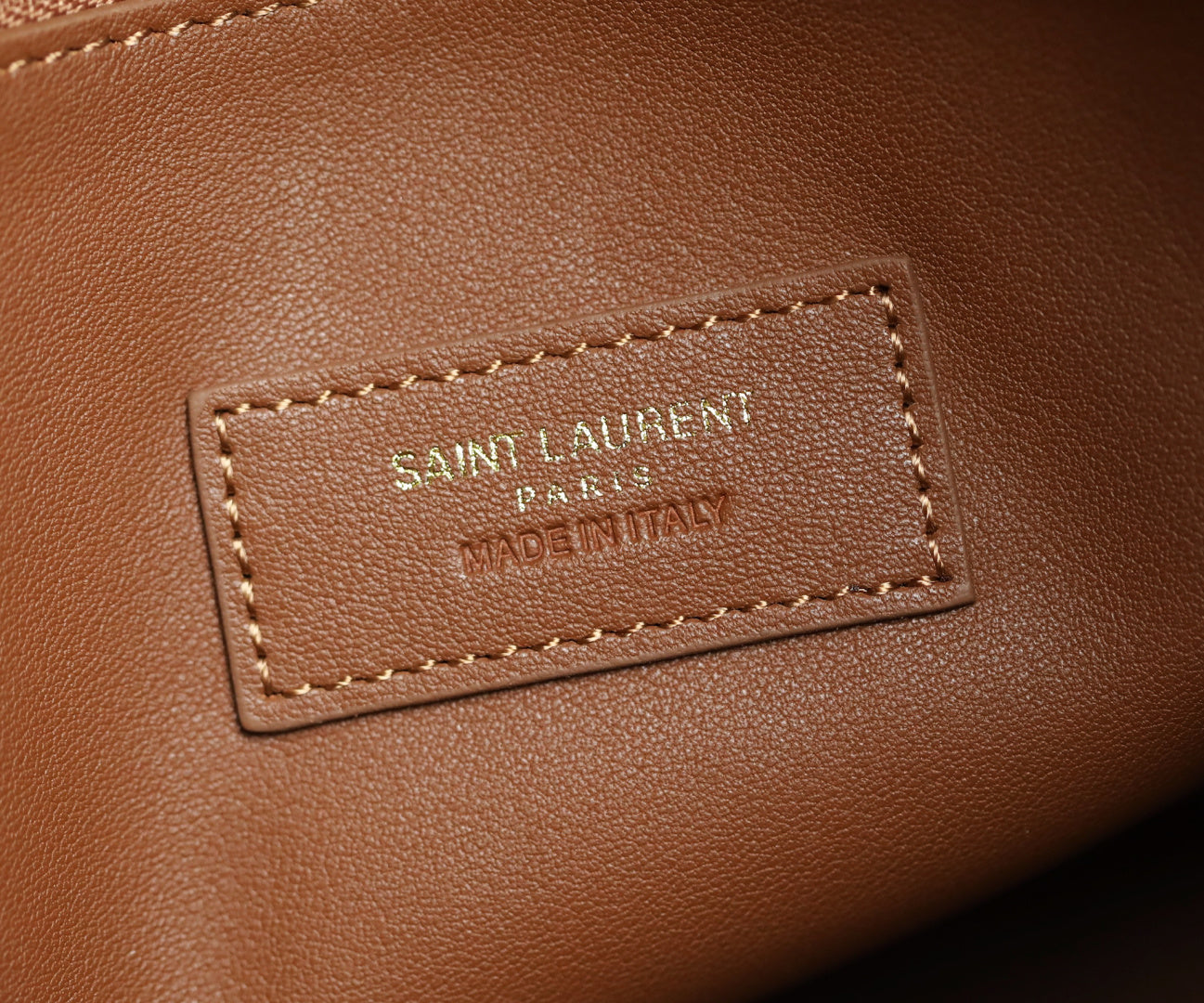YSL leather bag logo patch with 'SAINT LAURENT' and 'MADE IN ITALY'
