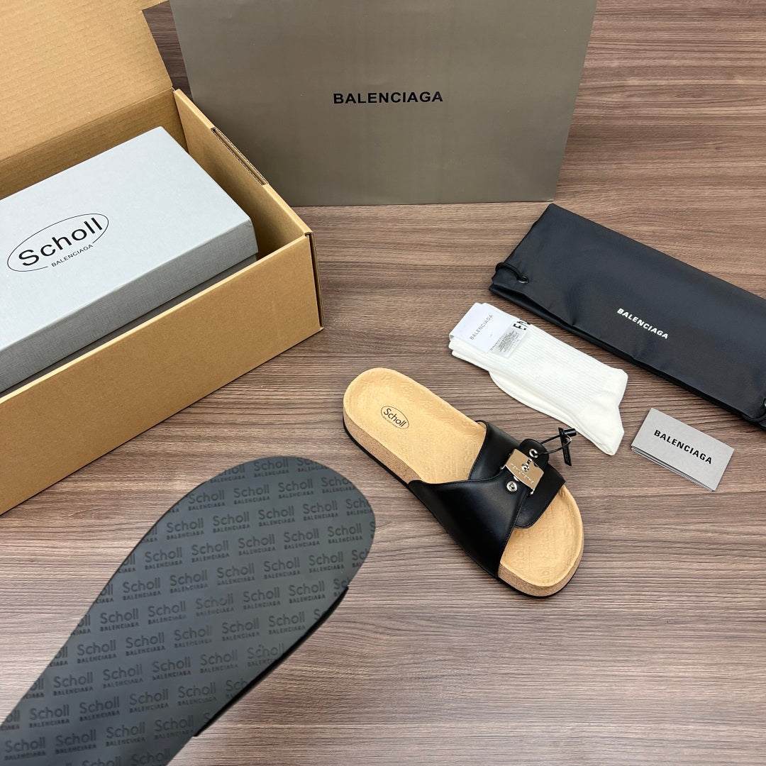 Black slide sandal with strap and cork-textured footbed, sole tread visible