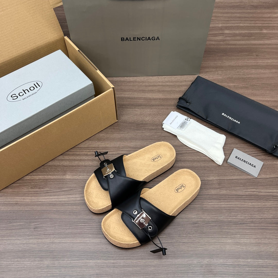 Black leather sandals with crossover straps, silver buckles, and cork-textured sole