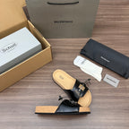 Balenciaga sandals with black leather straps, silver buckle details, tan cork footbed.