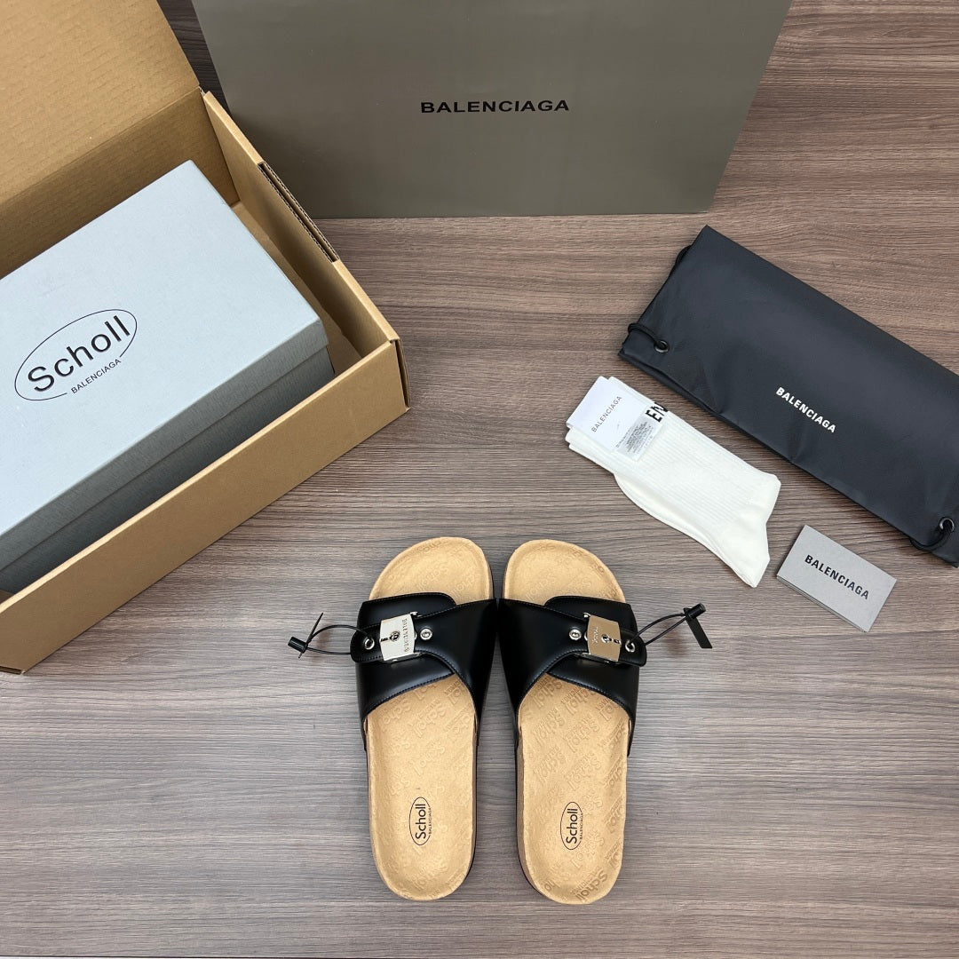 Balenciaga sandals pair, black leather cross straps with silver buckles, tan footbed.