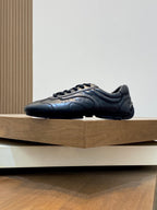 Black Prada unisex lace-up sneaker side view, stitched panels and rubber sole