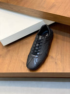 Black Prada unisex low-top sneakers, lace-up front and cushioned tongue