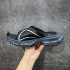 Balenciaga slide sandals with silver-gray strap insert, perforations, and chunky textured sole