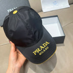 Black Prada baseball cap, close-up of side logo panel and yellow-edged brim