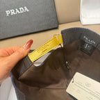Prada cap close-up of interior label area with black and yellow strap detail.