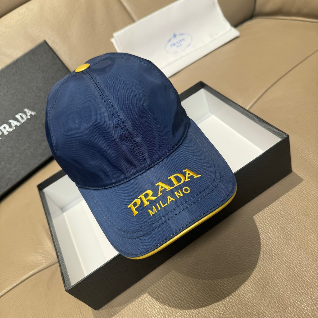 Prada cap in blue with yellow “PRADA MILANO” logo on the front panel.
