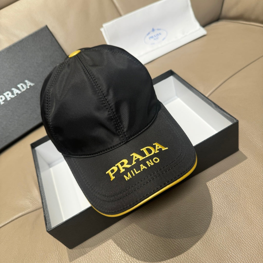 Black Prada baseball cap with gold “PRADA MILANO” logo and yellow trim
