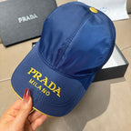 Prada cap in blue with yellow-edged brim and embroidered “PRADA MILANO” lettering.