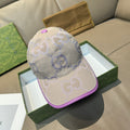 Gucci GG canvas baseball cap, light beige with purple trim and top button.
