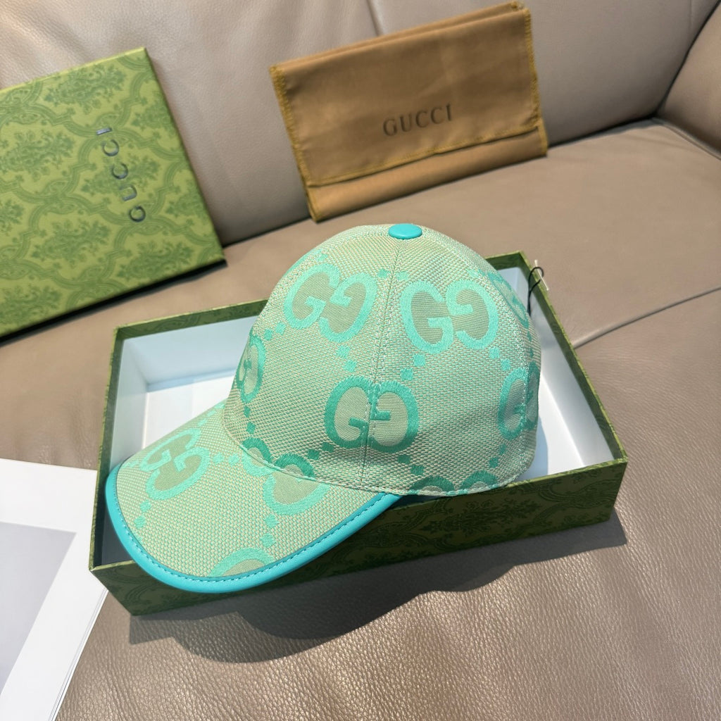 Gucci turquoise cap with teal brim edge and repeating GG logo pattern, front view