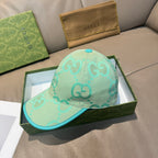 Gucci turquoise cap with teal brim edge and repeating GG logo pattern, front view