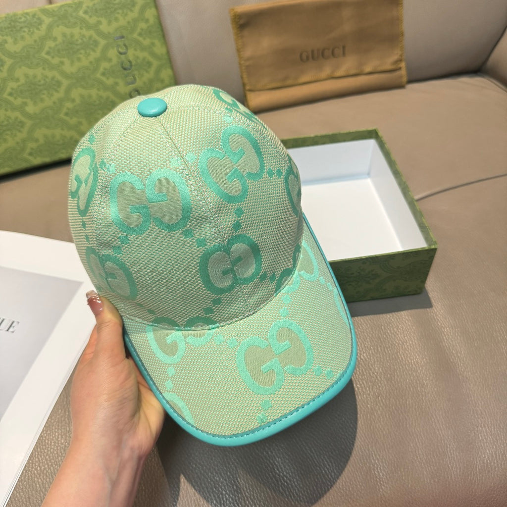 Gucci turquoise cap with GG logo print, teal brim, and matching top button