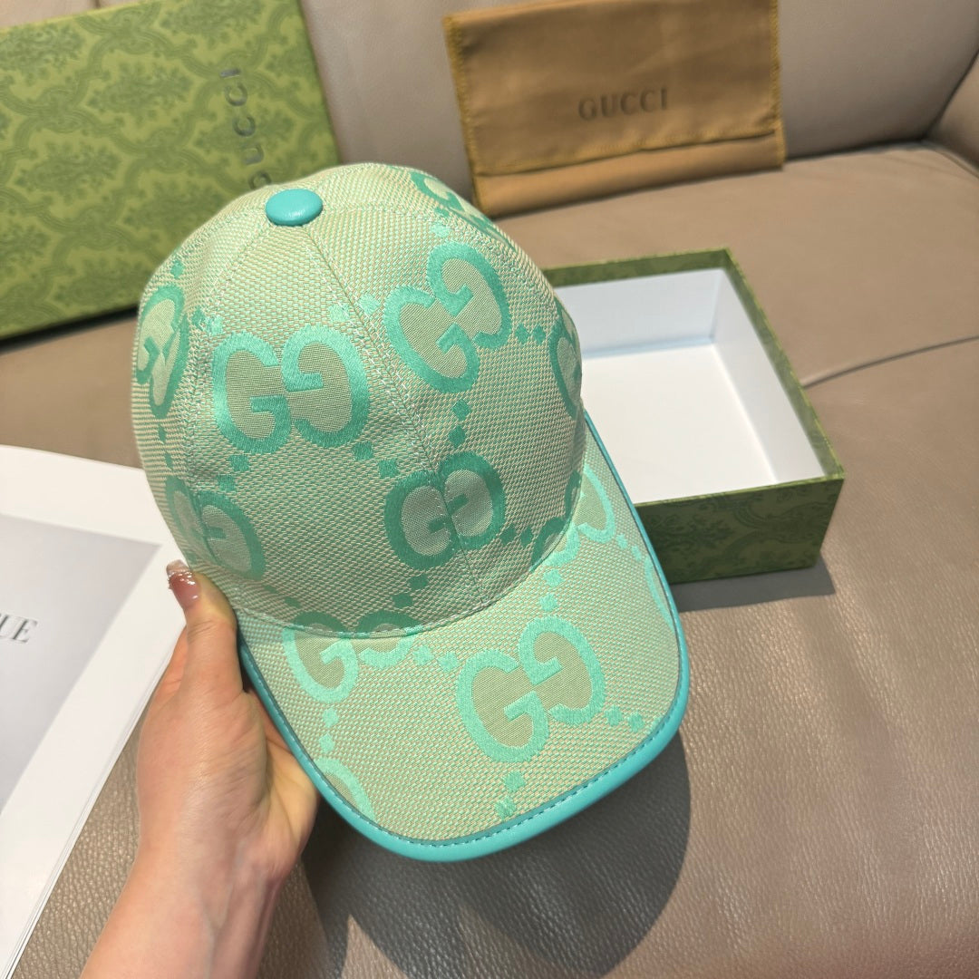 Gucci turquoise cap with GG logo print, teal brim, and matching top button