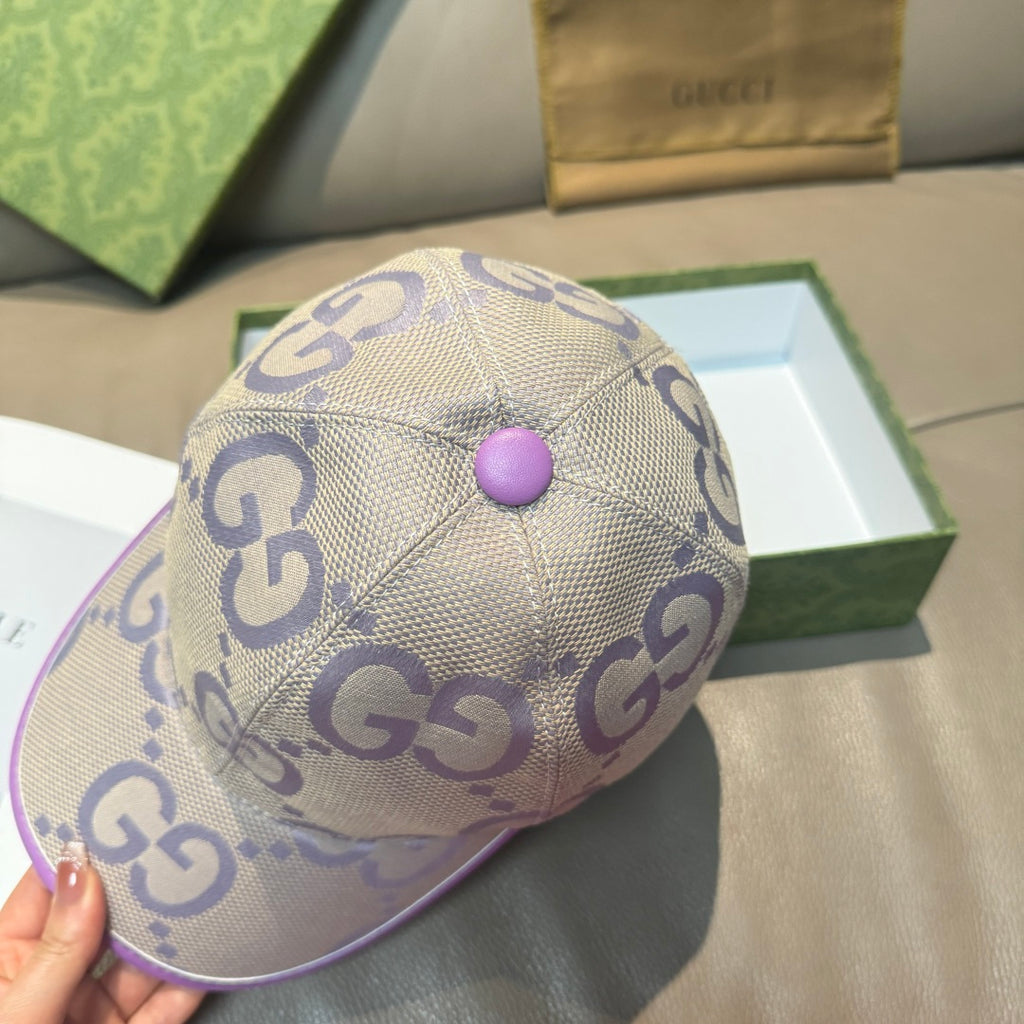 Gucci GG canvas baseball cap, light beige with purple top button and curved brim.