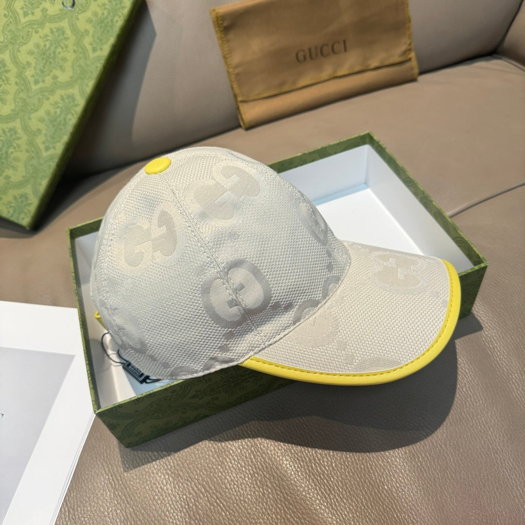 Gucci cap angled view in white with GG logo pattern and yellow brim trim