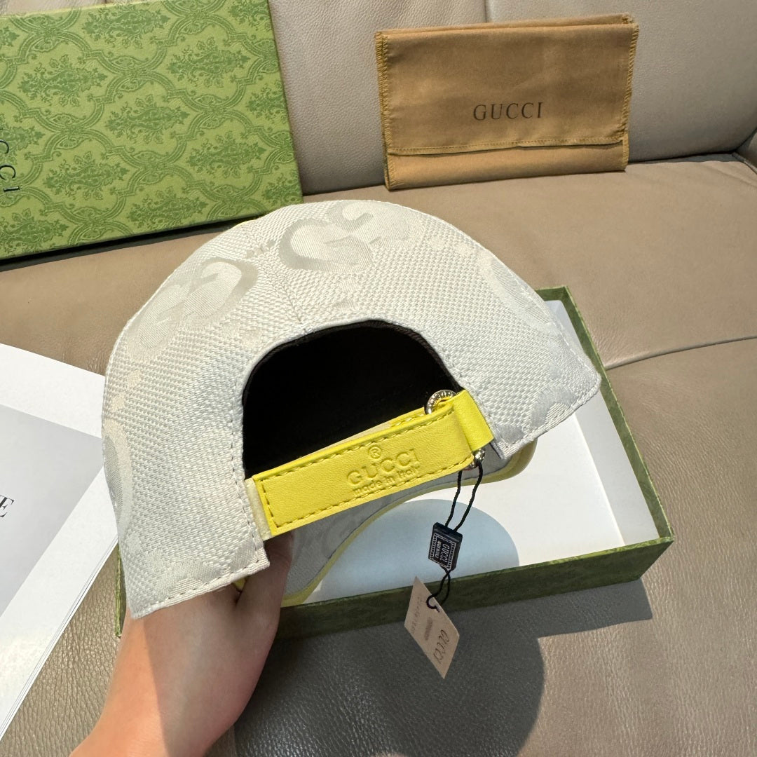 Gucci cap side view: white GG-pattern fabric with yellow adjustable strap