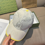 Gucci cap front view in white with GG pattern and yellow brim edge