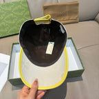 Gucci cap with black interior lining and yellow underbrim; fabric shows GG pattern