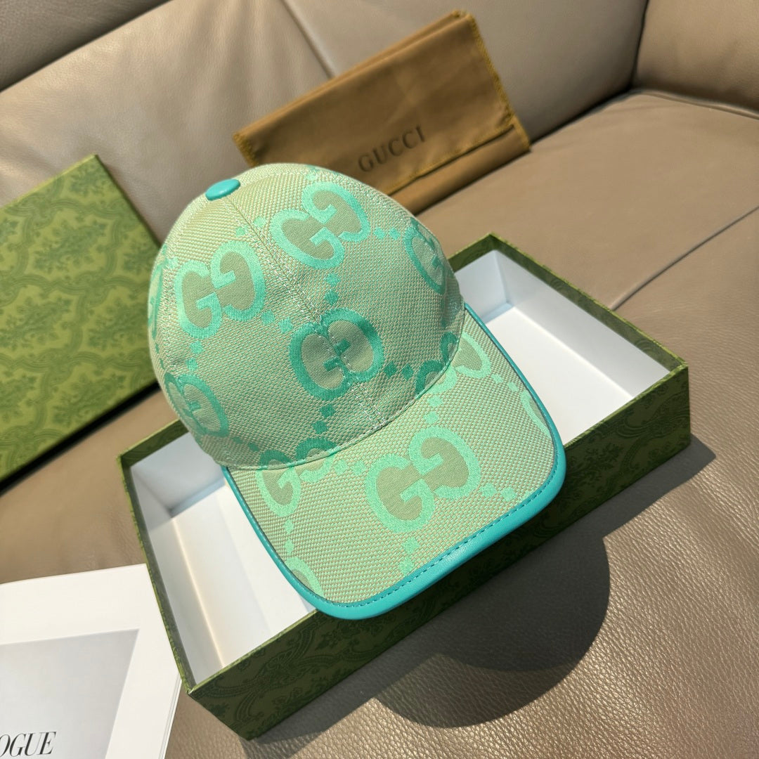 Gucci cap in turquoise mesh with teal trim and repeating GG logo pattern
