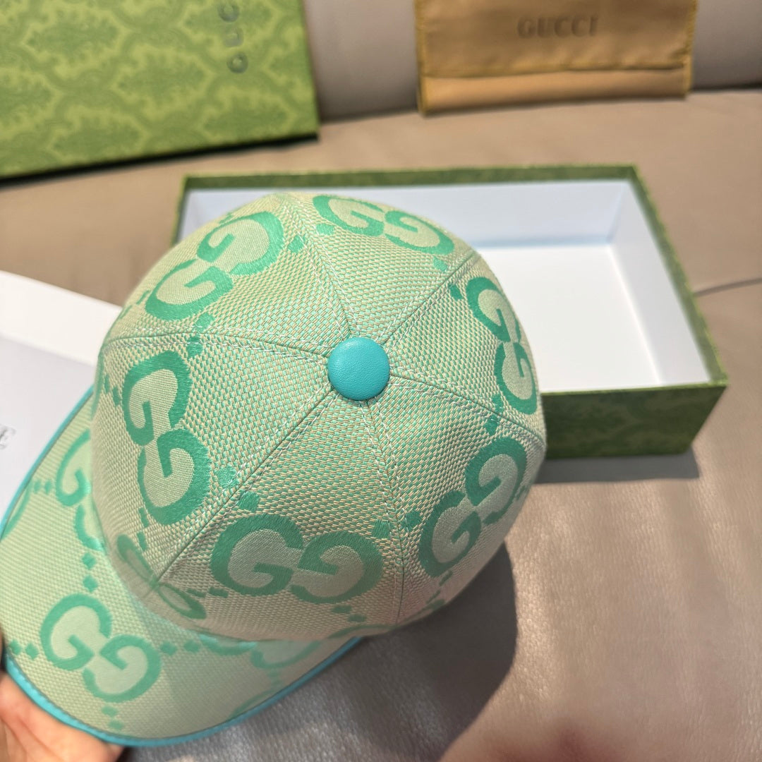 Gucci turquoise cap showing top panel seam and GG logo pattern, teal button