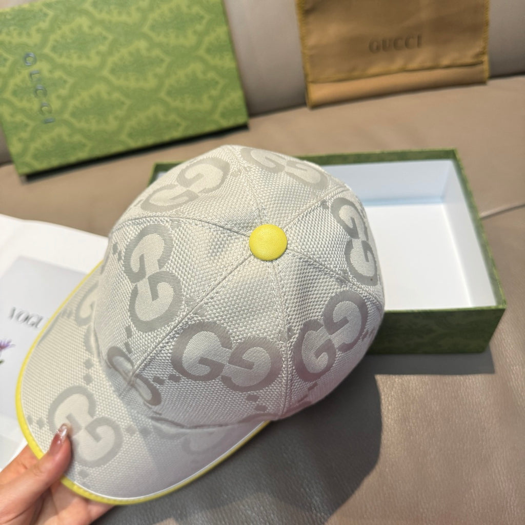 Gucci cap top view in white with GG monogram pattern and yellow center button