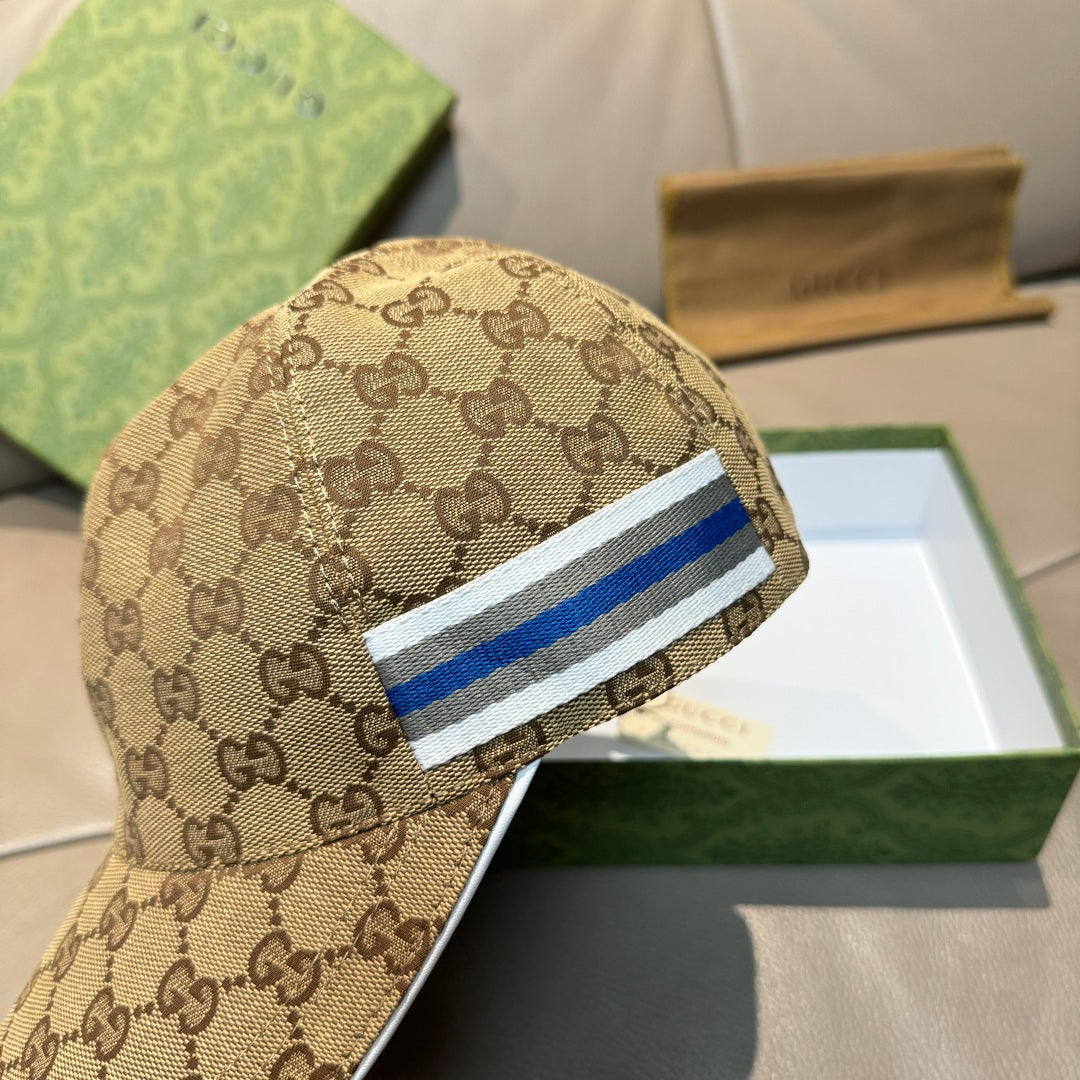 Brown GG monogram baseball cap with blue-and-white striped band and curved brim