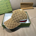 Beige GG monogram baseball cap with red, white, and blue stripe band