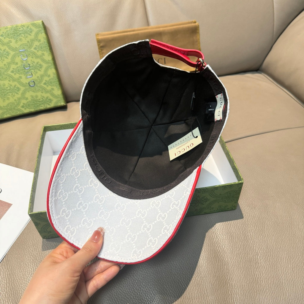 Gucci cap with black interior view and GG-pattern front panel with red-trim edge.