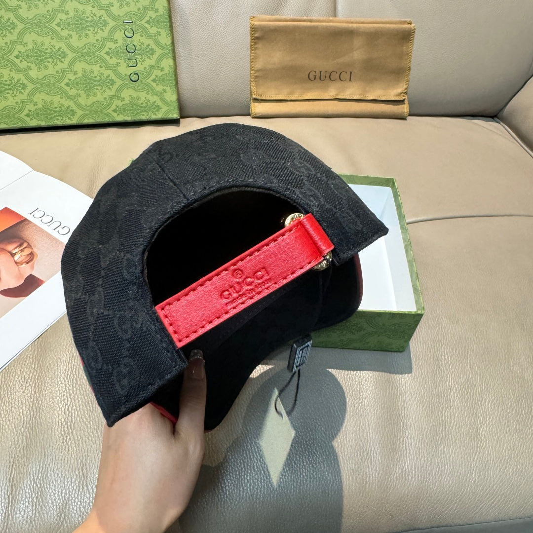 Black GG-pattern baseball cap with red logo patch and curved brim opening visible.