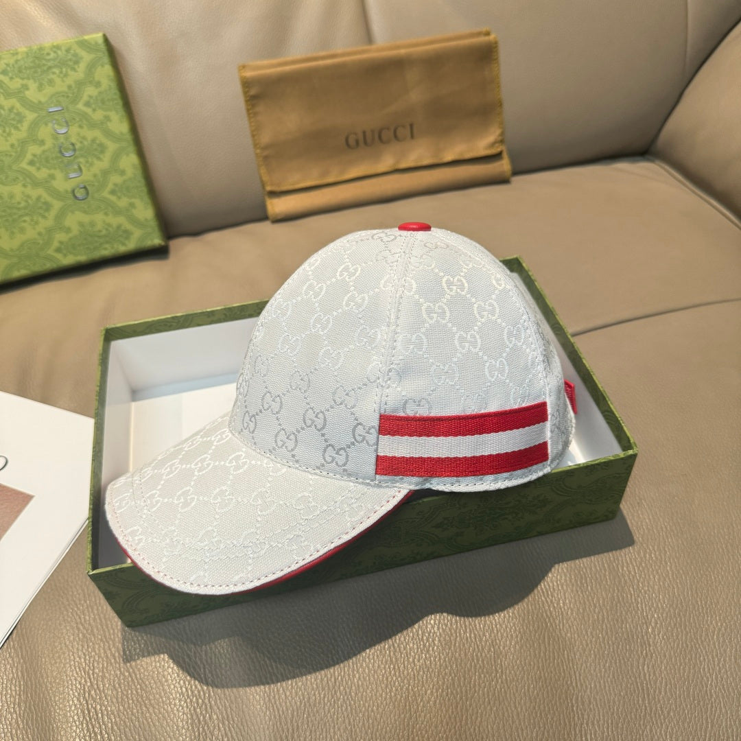 Gucci cap in white with GG pattern and red-and-blue web stripe at the front.
