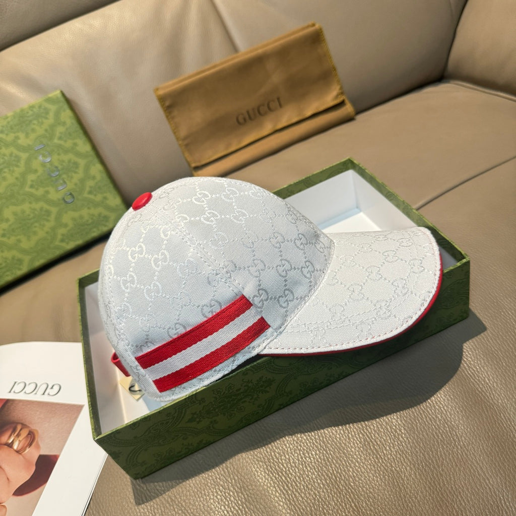 Gucci cap with white GG monogram fabric and red stripe across the front panel.