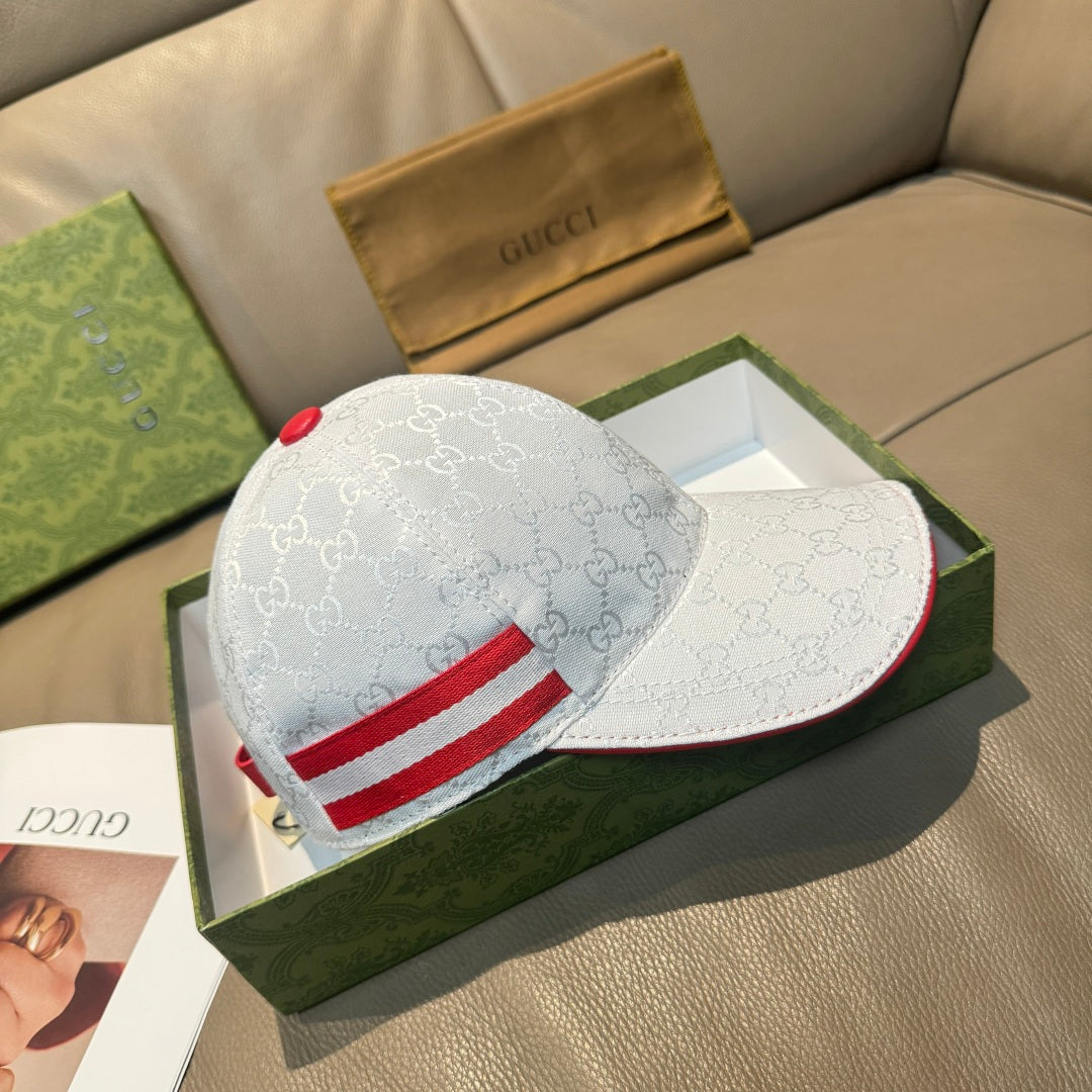 Gucci cap with white GG monogram fabric and red stripe across the front panel.