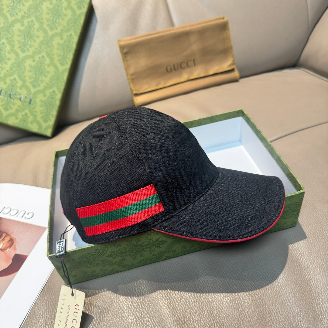 Black GG-pattern baseball cap with red and green Web stripe; curved brim visible.