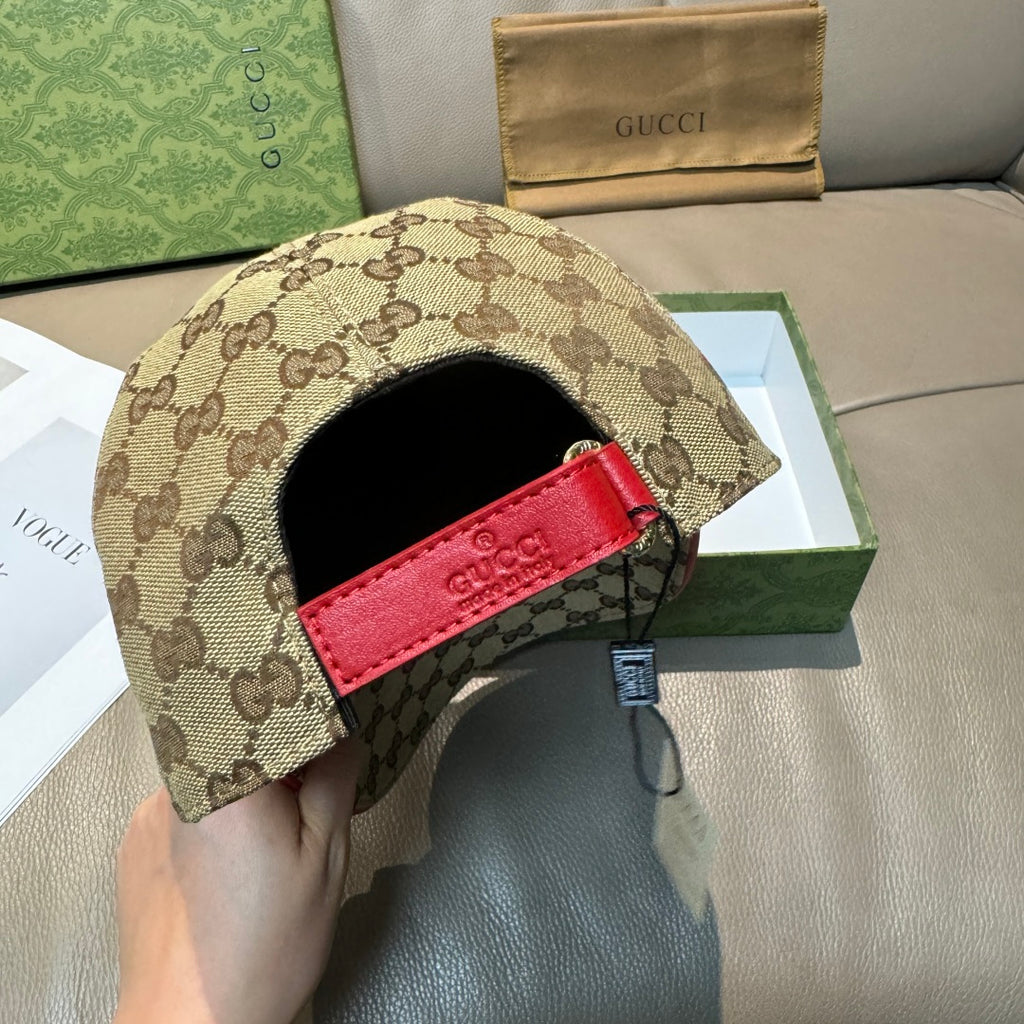 Gucci baseball cap with tan GG canvas and red leather strap on back panel