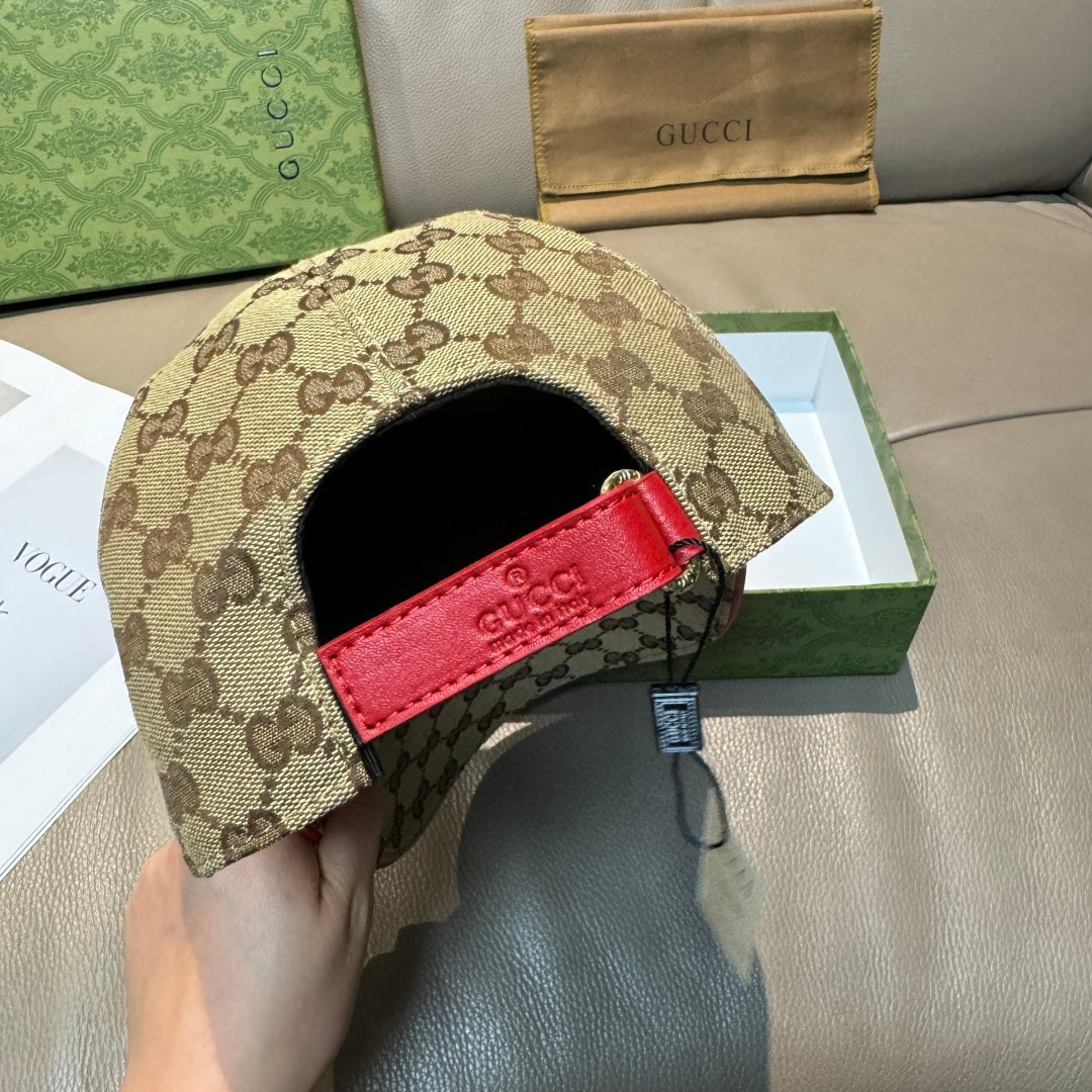 Gucci baseball cap with tan GG canvas and red leather strap on back panel