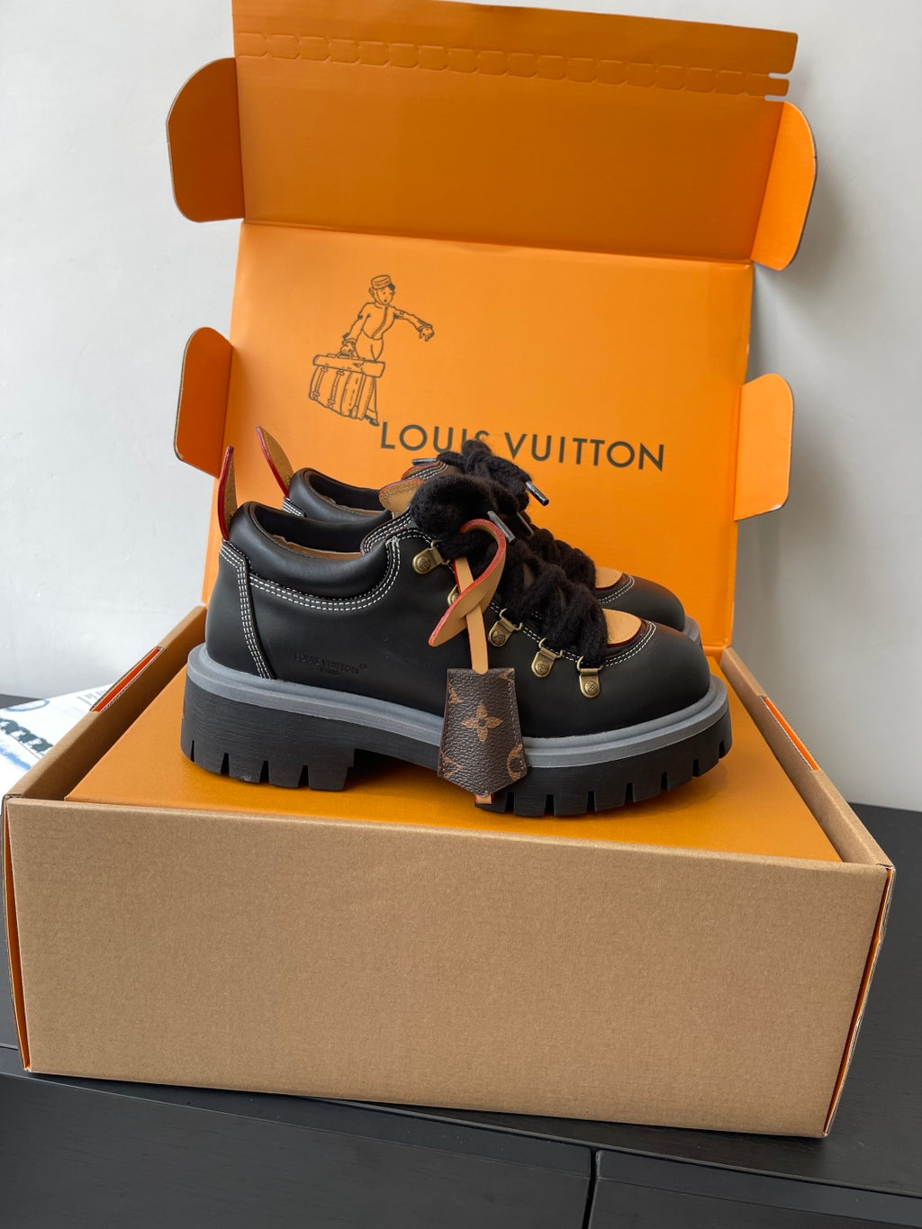 Louis Vuitton ladies sneakers: black lace-up with gold eyelets, fur trim, thick sole