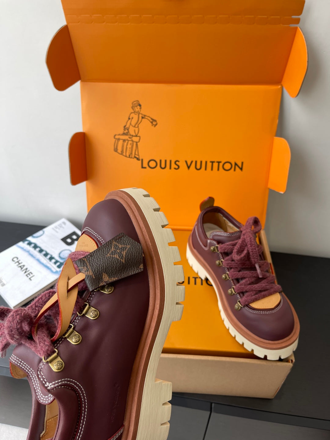 Louis Vuitton women's sneakers, one shoe showing upper profile with dark purple leather-look