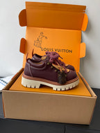 Louis Vuitton women's sneakers with dark purple upper, purple laces, and white-tan tread sole